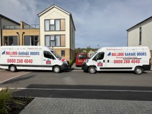 Bulldog Garage doors, two of our new vans outside a customer's home. 